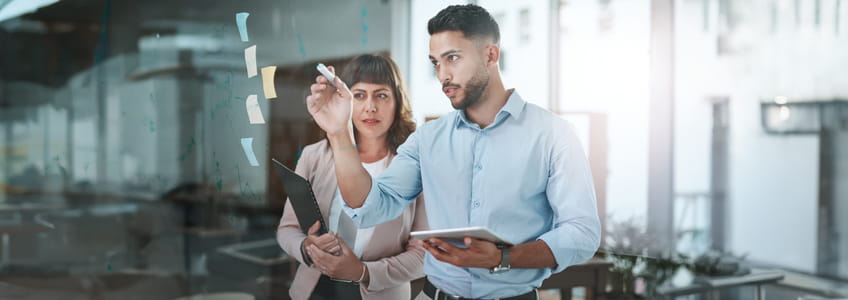 A gentleman and a lady are engaged in a brainstorming session in the office