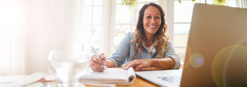 woman smiling infront of computer