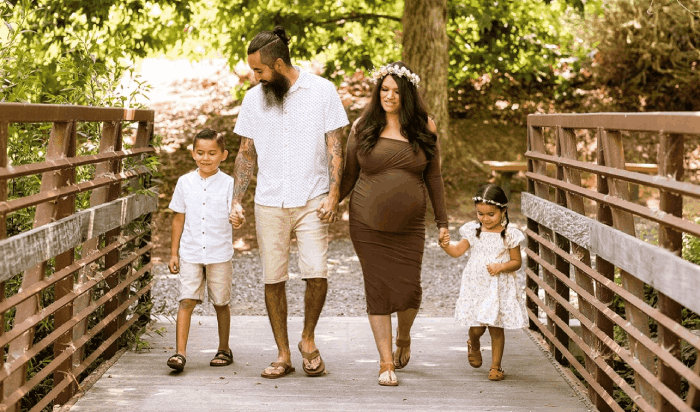 Scholarship winner Krystal Rivera walking over a bridge with her husband and two of their children.