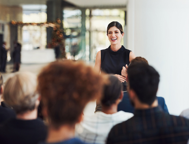 Shot of a young businesswoman delivering a speech during a conference