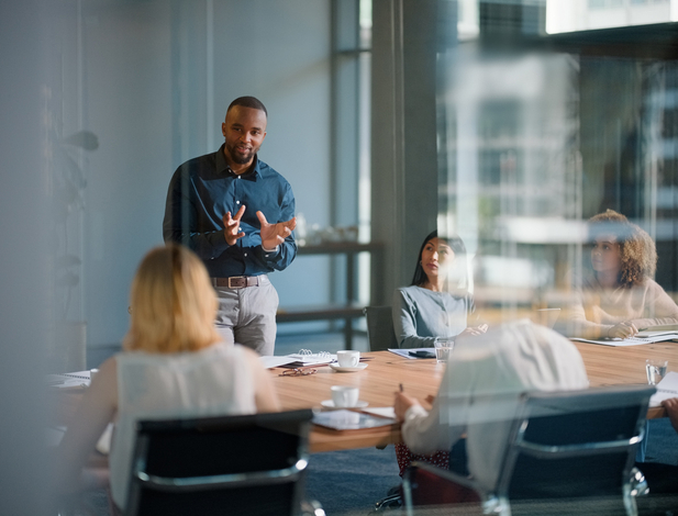 Businessman, meeting and discussion with office, boardroom and collaboration or workshop. Leader, training and presentation for mentor, coaching and strategy for teamwork and planning with startup